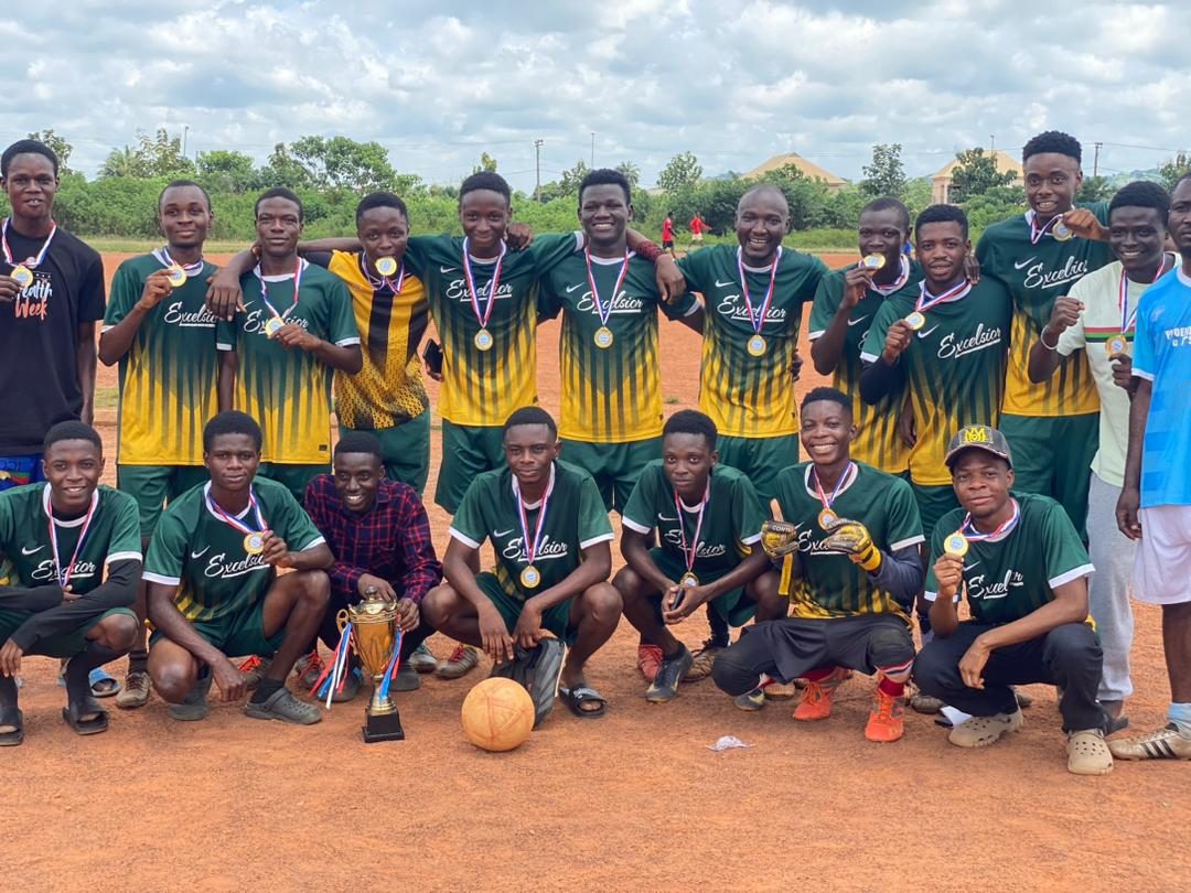 Excelsior FC players with a trophy and winners' medals